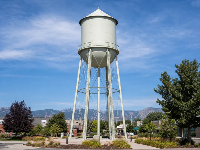 Olde Town Arvada water tower above its landscaped plaza and historic district
