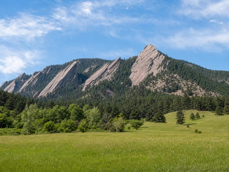 Flatirons rising behind the open lawn at Chautauqua Park in Boulder