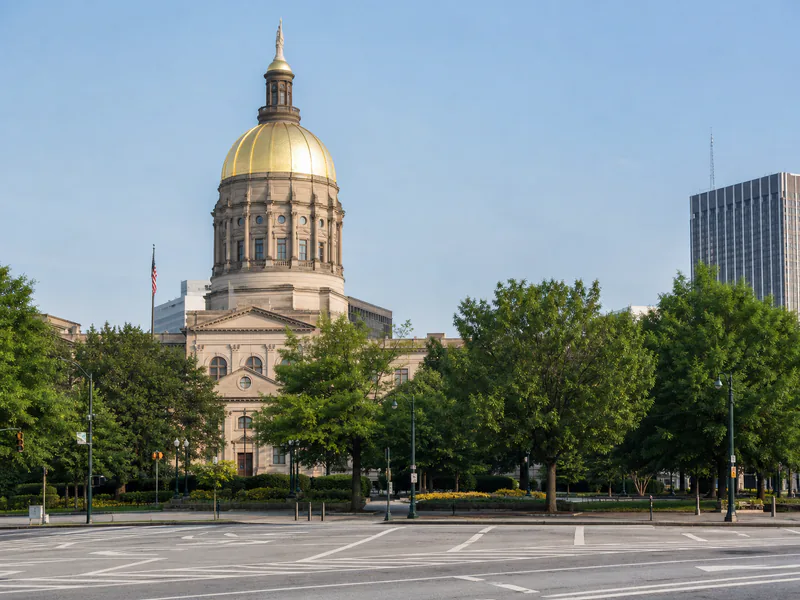 Gold dome of the Georgia State Capitol with authentic downtown Atlanta context