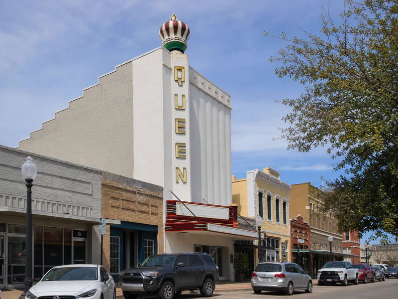 Restored Queen Theatre facade and crown sign in Bryan